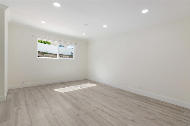 unfurnished room featuring light wood-type flooring, baseboards, and ornamental molding