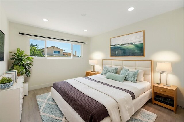 bedroom featuring recessed lighting, baseboards, and light wood-style floors