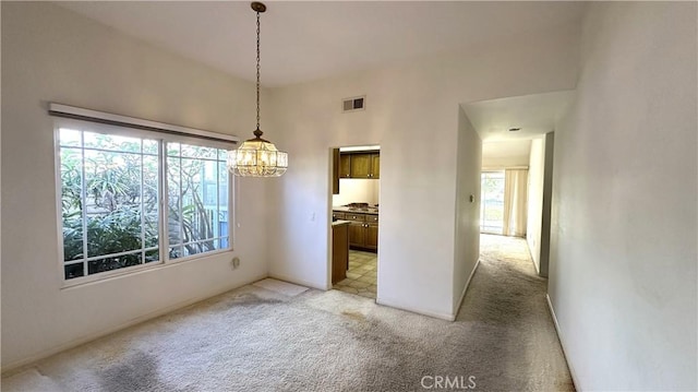 unfurnished dining area featuring light colored carpet and visible vents