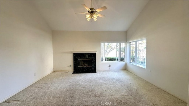 unfurnished living room with high vaulted ceiling, a ceiling fan, carpet floors, and a premium fireplace