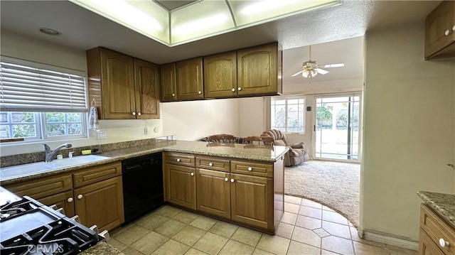 kitchen with a sink, plenty of natural light, dishwasher, and brown cabinets