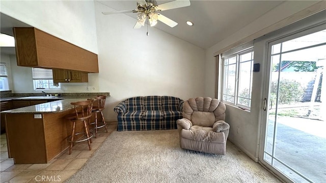 interior space with light tile patterned floors, recessed lighting, high vaulted ceiling, and ceiling fan