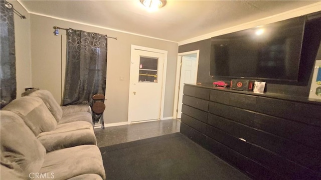 living area with baseboards and crown molding