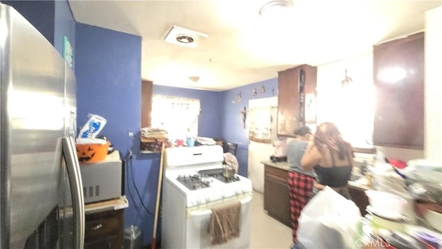 kitchen featuring washer / dryer and freestanding refrigerator