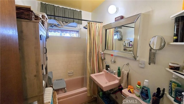 full bath with a sink and shower / bath combination with curtain