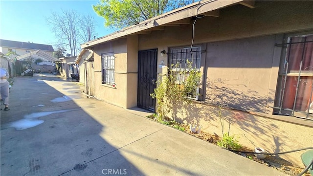 view of side of home featuring stucco siding