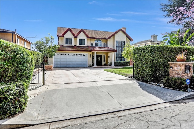 view of front of house with driveway, a garage, a chimney, a tiled roof, and stucco siding