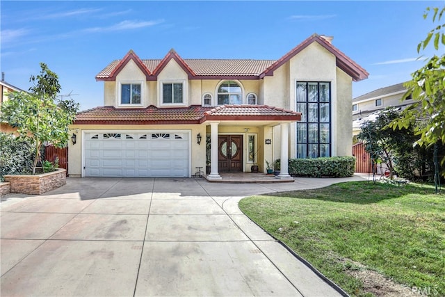 mediterranean / spanish-style house featuring a tile roof, stucco siding, fence, driveway, and a front lawn