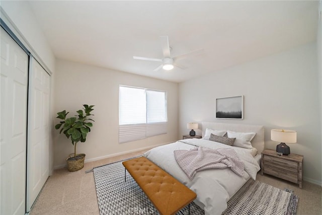 bedroom featuring ceiling fan, a closet, carpet, and baseboards