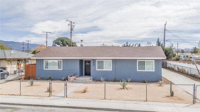 view of front of property featuring a fenced front yard, a gate, and stucco siding