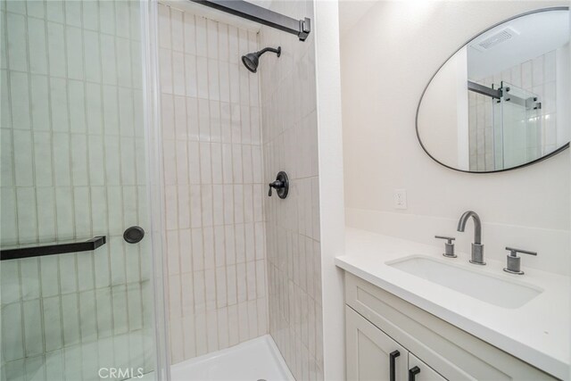 full bath featuring visible vents, a shower stall, and vanity