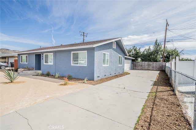 ranch-style house with crawl space, fence, concrete driveway, and stucco siding