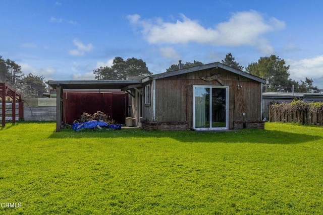 back of house featuring a yard and fence