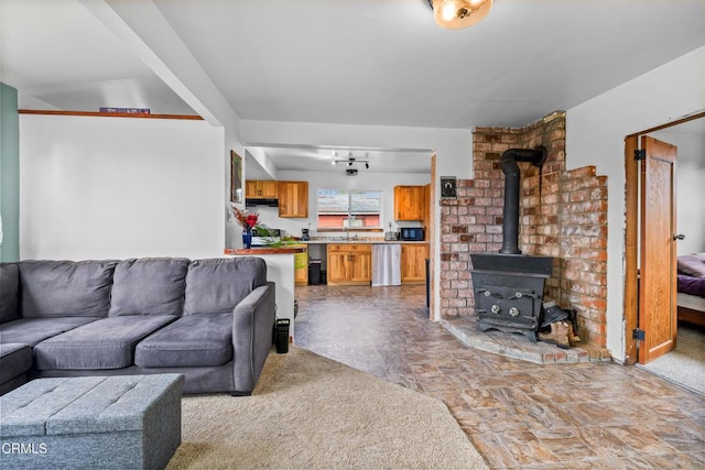 living area with stone finish floor and a wood stove