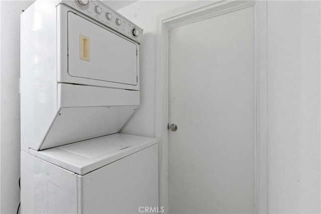 laundry area with stacked washer / dryer and laundry area