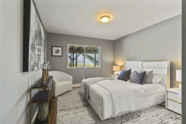 bedroom featuring baseboards and wood finished floors