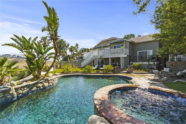 outdoor pool featuring a deck, a patio, and stairway