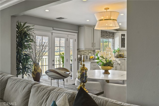 interior space featuring recessed lighting, visible vents, a wealth of natural light, and french doors