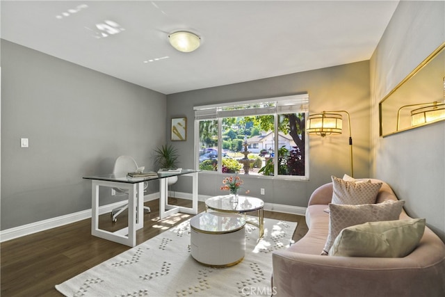 living area with wood finished floors and baseboards