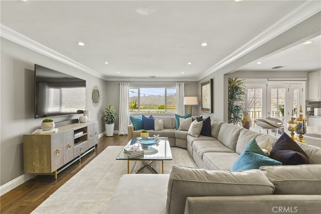 living area featuring dark wood-style floors, crown molding, and baseboards