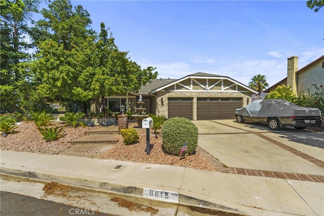 view of front of house featuring concrete driveway and an attached garage