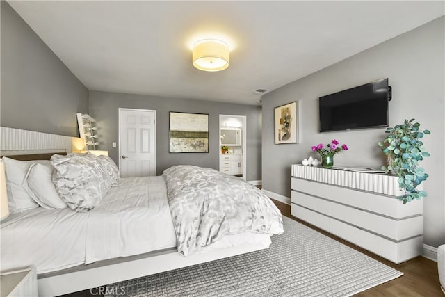 bedroom with wood finished floors, visible vents, and baseboards