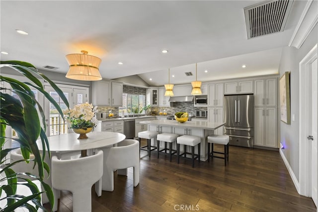 dining space featuring baseboards, visible vents, dark wood-style floors, vaulted ceiling, and recessed lighting