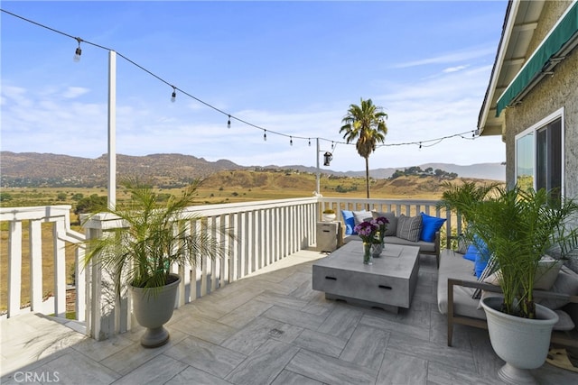 view of patio featuring an outdoor hangout area and a mountain view