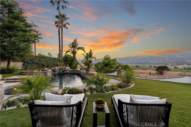 view of property's community featuring an outdoor hangout area and a lawn