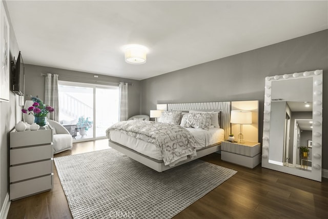 bedroom with access to outside, baseboards, and wood finished floors