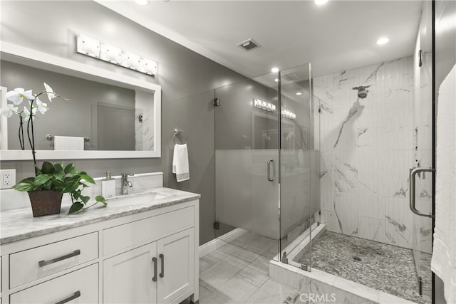 full bathroom with recessed lighting, a marble finish shower, visible vents, and vanity