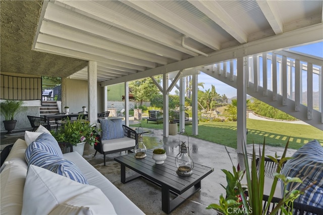 sunroom featuring plenty of natural light and beamed ceiling