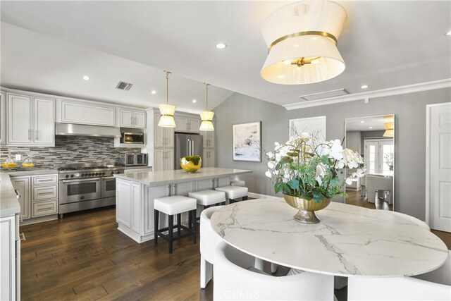 dining space with lofted ceiling, dark wood finished floors, visible vents, and recessed lighting