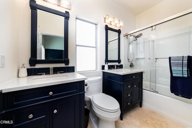 bathroom with combined bath / shower with glass door, vanity, toilet, and tile patterned floors