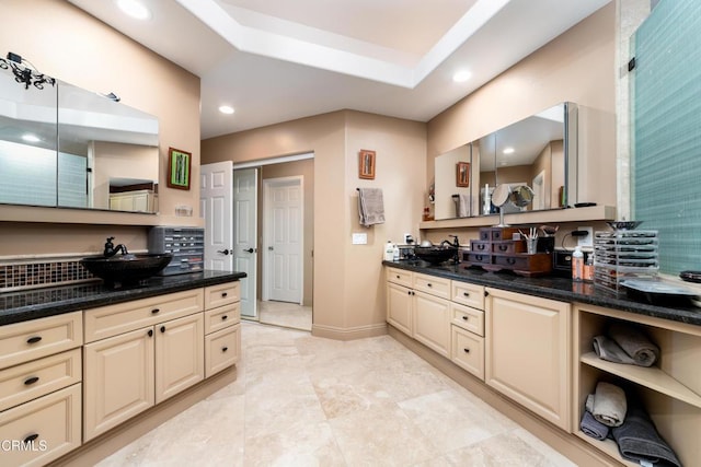 full bathroom with baseboards, two vanities, a sink, and recessed lighting