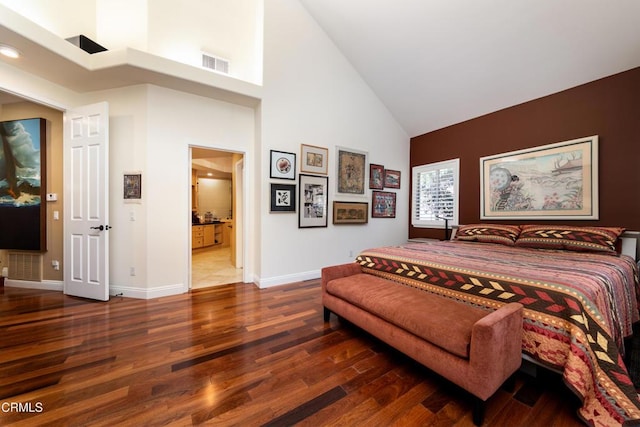 bedroom featuring high vaulted ceiling, visible vents, baseboards, and wood finished floors