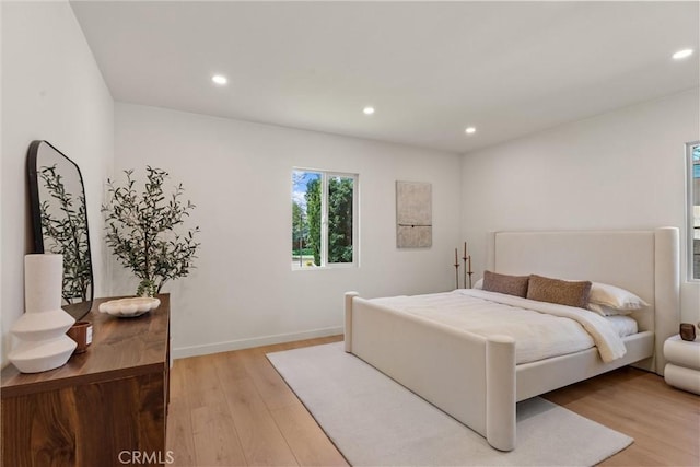 bedroom with recessed lighting, light wood-style flooring, and baseboards