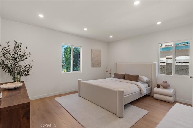 bedroom featuring light wood-style floors, baseboards, and recessed lighting