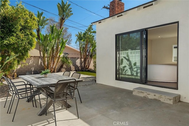 view of patio / terrace featuring outdoor dining space and fence