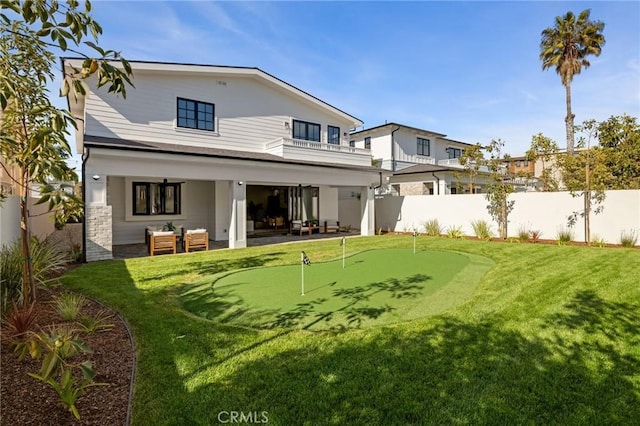 1820 9th St, Manhattan Beach, CA 90266 - rear view of house with a patio area, a fenced backyard, stone siding, and a balcony