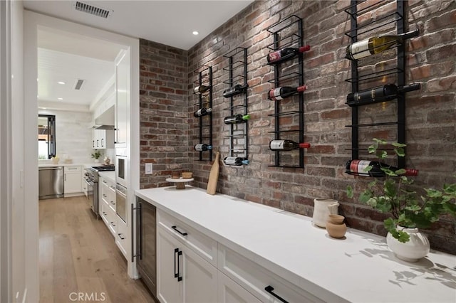 1820 9th St, Manhattan Beach, CA 90266 - wine cellar featuring brick wall, light wood finished floors, and visible vents