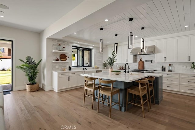 1820 9th St, Manhattan Beach, CA 90266 - kitchen with tasteful backsplash, plenty of natural light, wall chimney exhaust hood, and light countertops