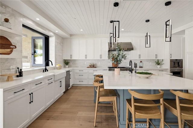 1820 9th St, Manhattan Beach, CA 90266 - kitchen with a kitchen bar, wood ceiling, appliances with stainless steel finishes, a sink, and backsplash