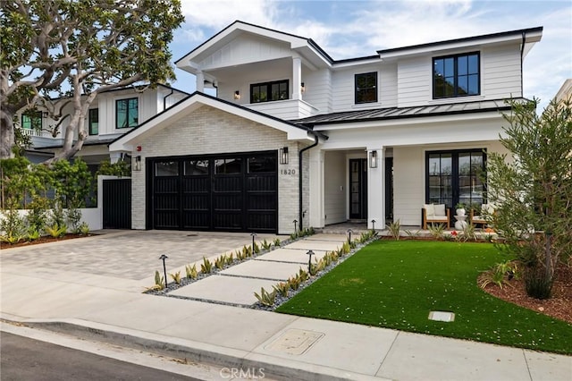 1820 9th St, Manhattan Beach, CA 90266 - view of front facade with a standing seam roof, an attached garage, metal roof, a front lawn, and driveway
