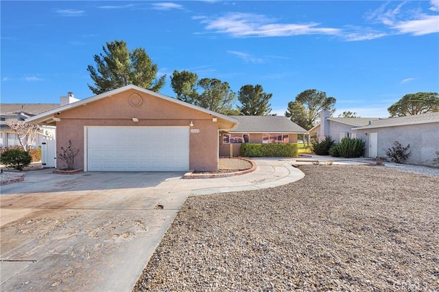 single story home featuring concrete driveway, an attached garage, and stucco siding