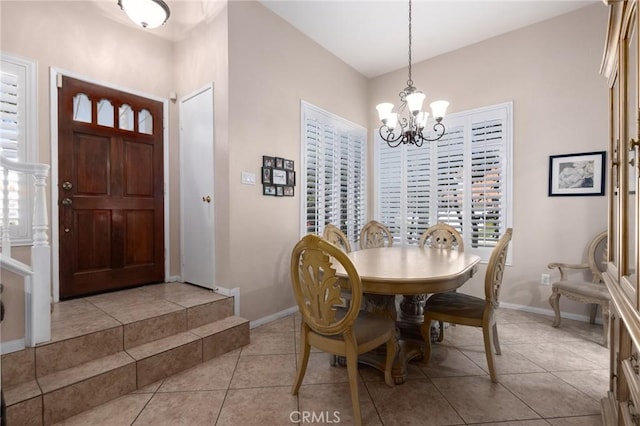 dining room featuring baseboards, light tile patterned flooring, a wealth of natural light, and an inviting chandelier