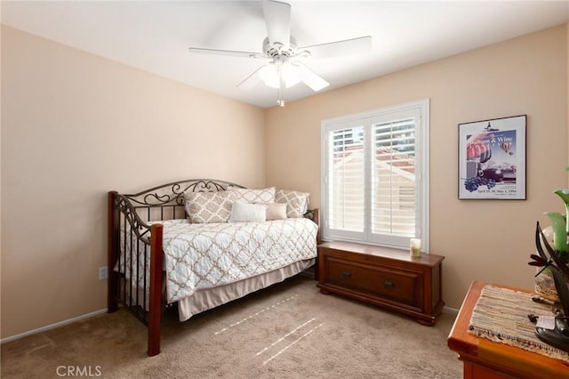 carpeted bedroom featuring ceiling fan and baseboards