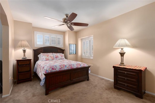 bedroom with a ceiling fan, baseboards, and carpet flooring