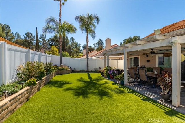 view of yard with a patio area, a fenced backyard, ceiling fan, and a pergola