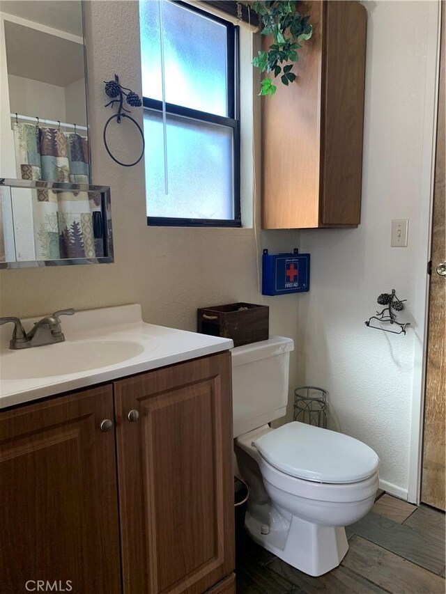 33492 Wild Rose Dr, Green Valley Lake, CA 92341 - full bathroom featuring vanity, toilet, and wood finished floors